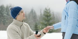 Man proposing to woman outdoors