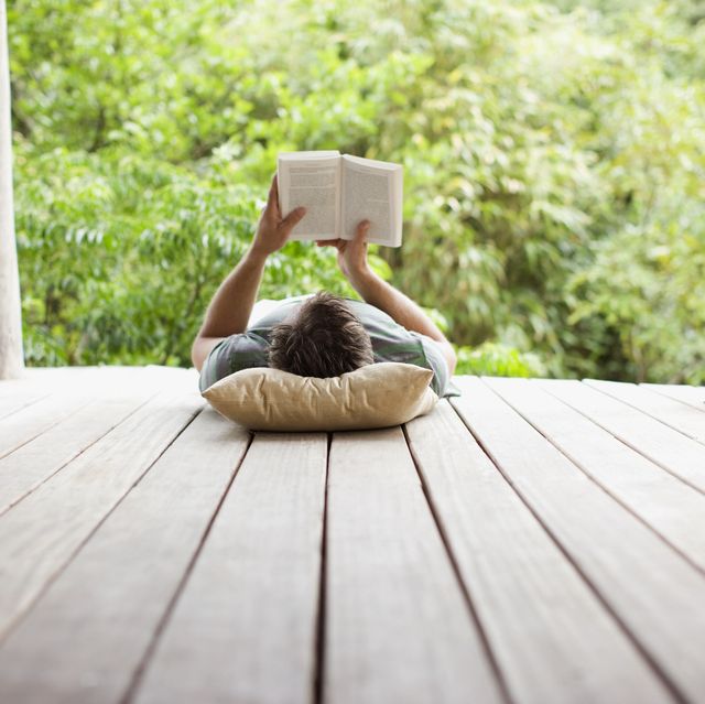 man reading on porch in remote area