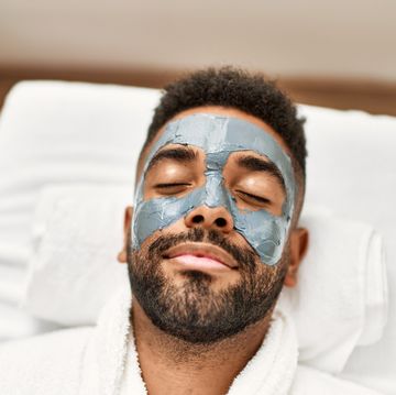 man relaxed with facial treatment at beauty center