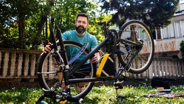 man repairing bicycle diy