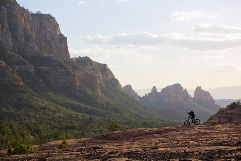 A man rides his enduro-style mountain bike at the end of the day in Sedona, Arizona, USA.