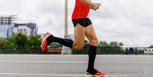 man runner in black compression socks run city marathon
