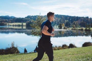 man running by the lake