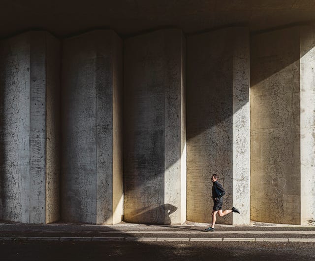 Man running in concrete underpass