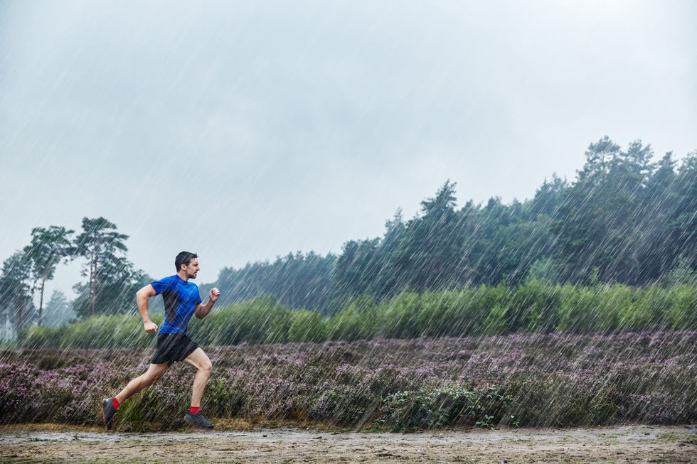 man running in heavy rain