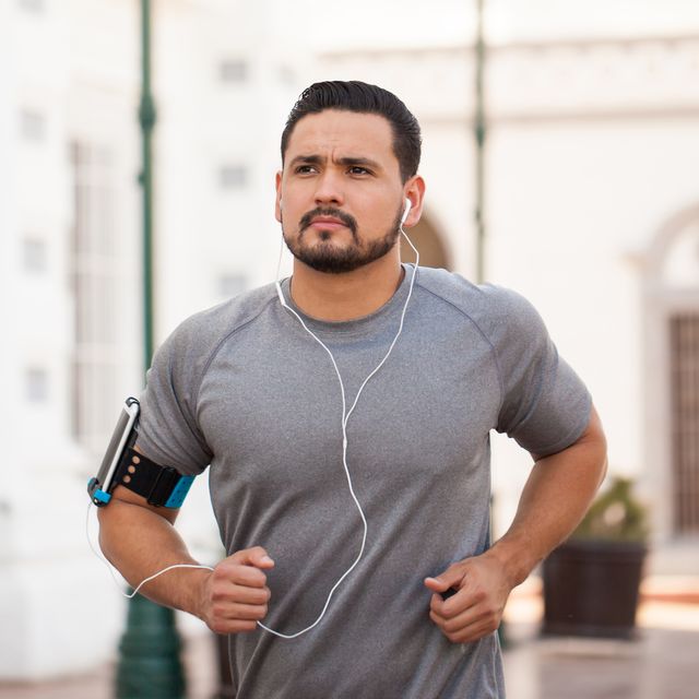 man running in the city and listening to music