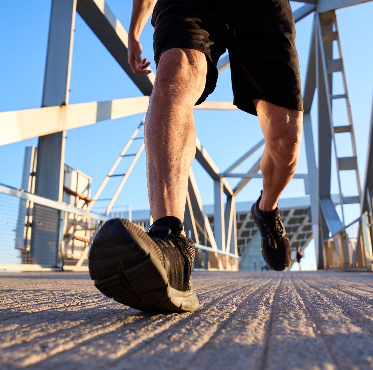 man running on a bridge in the city.