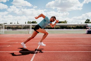 man running on tartan track