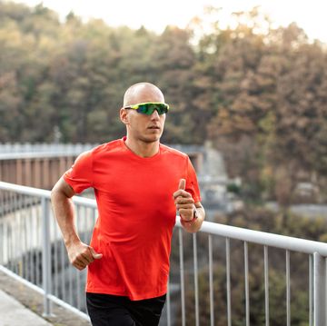 man running on the bridge in nature