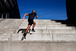 man running up outdoor stairs