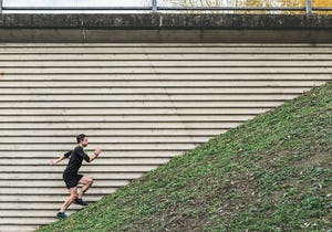 man running up steep hill