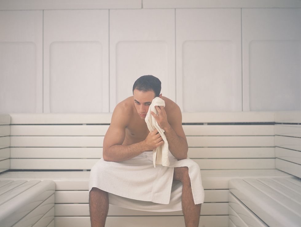 man sitting in sauna
