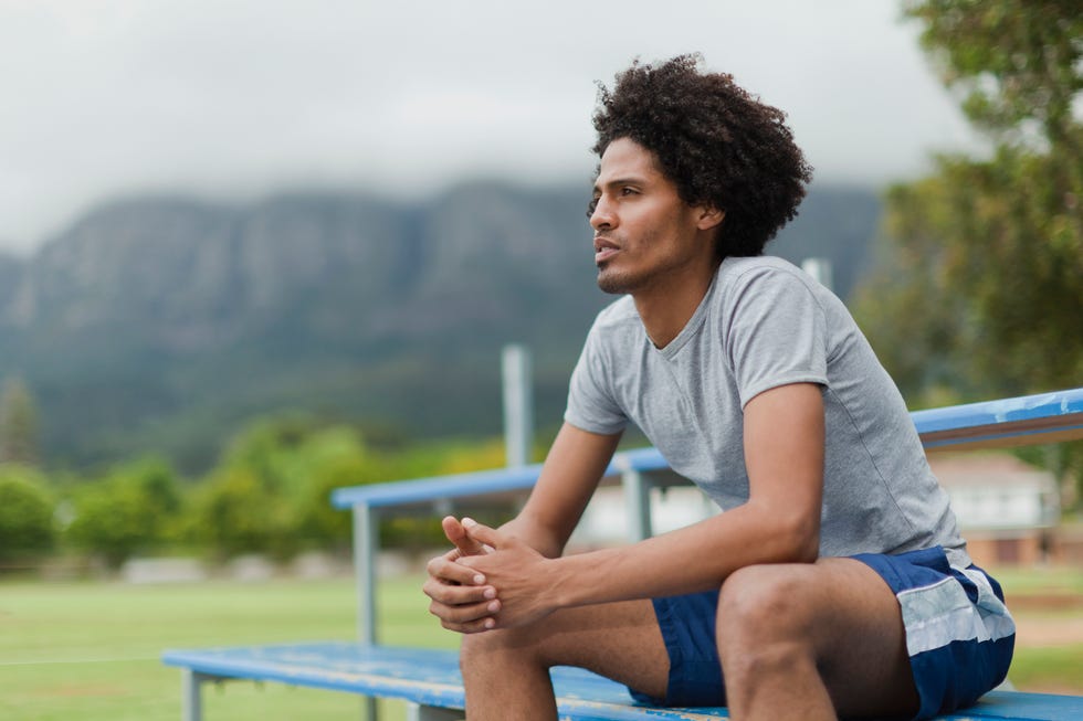 Man sitting on bleachers in park