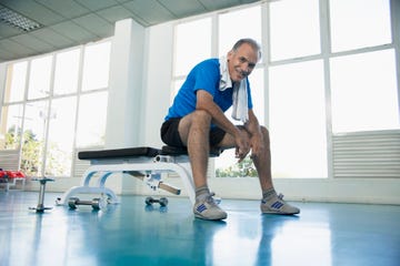 man sitting on exercise bench