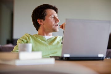 man sitting with laptop and thinking