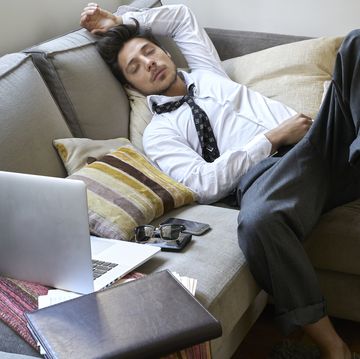 man sleeping on the couch exhausted