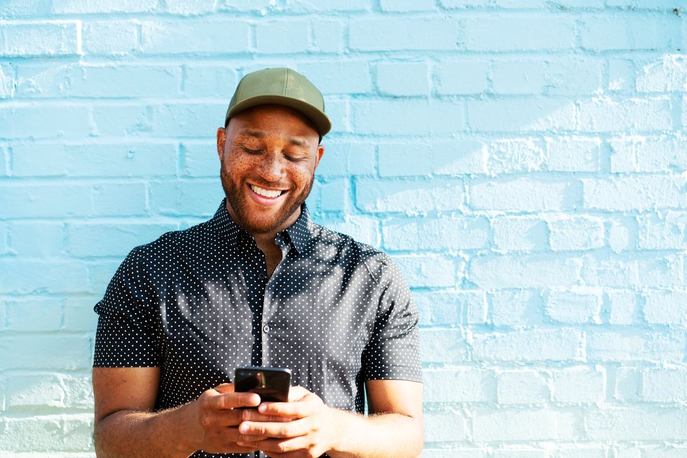 man smiling with smart phone