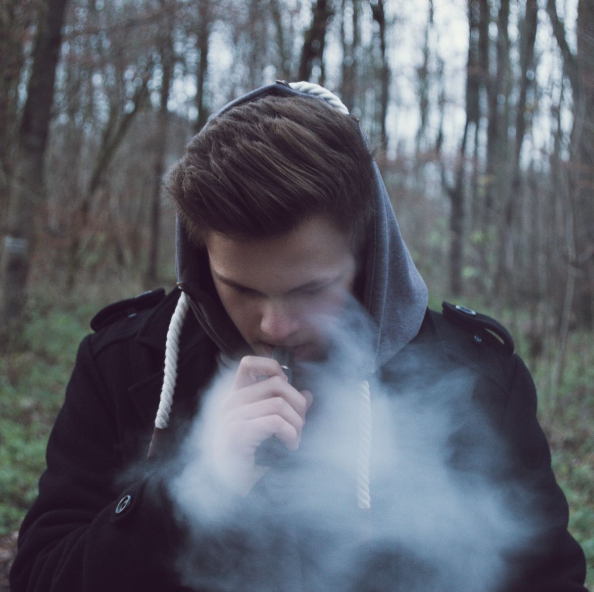 Man Smoking In Forest