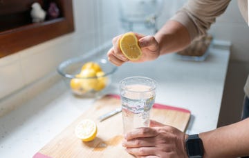 man squeezing out juice of lemon