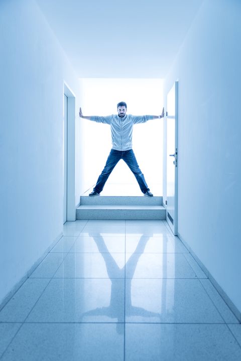 man standing in a bright corridor