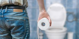 man suffers from diarrhea holds toilet paper roll