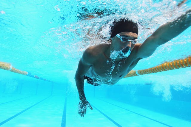 man swimming in pool, underwater
