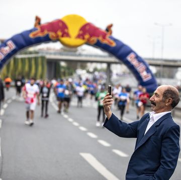 a man takes a selfie on his smartphone with the background...