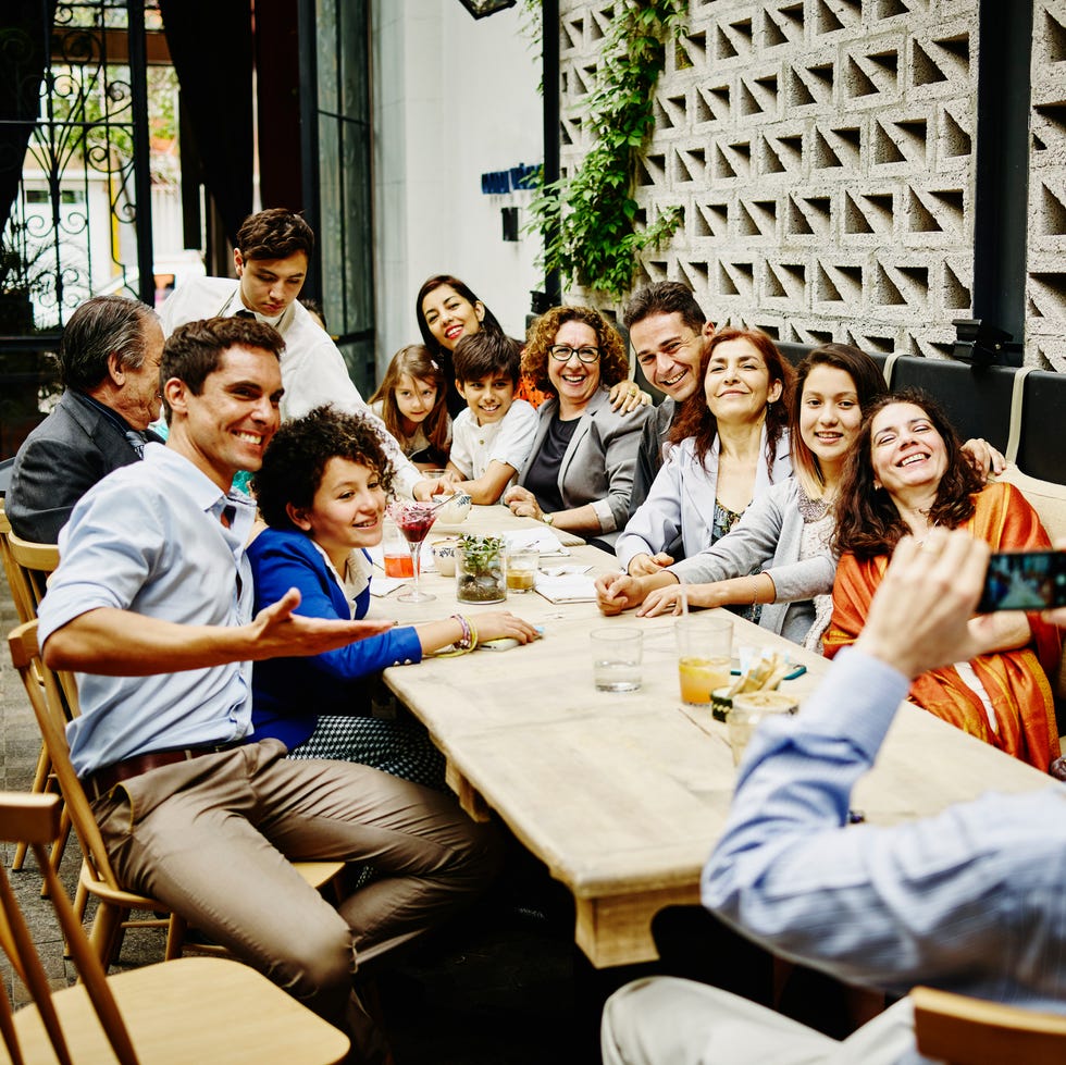 man taking family portrait in restaurant