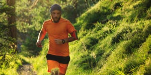 man trail running in the forest