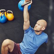 man training in gym with kettlebell