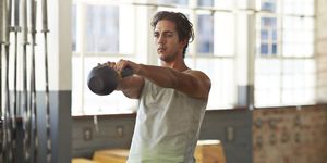 man training with kettlebell at gym gym
