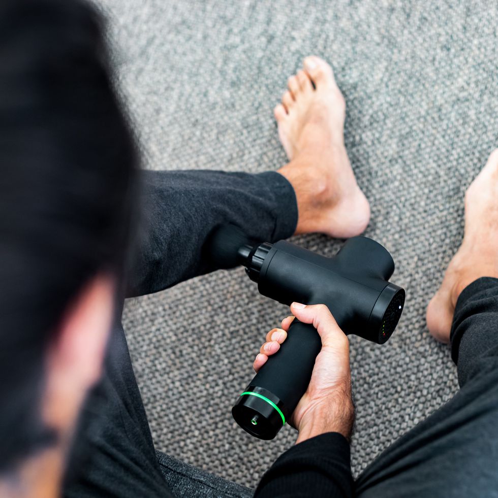 a man using massage gun  machine