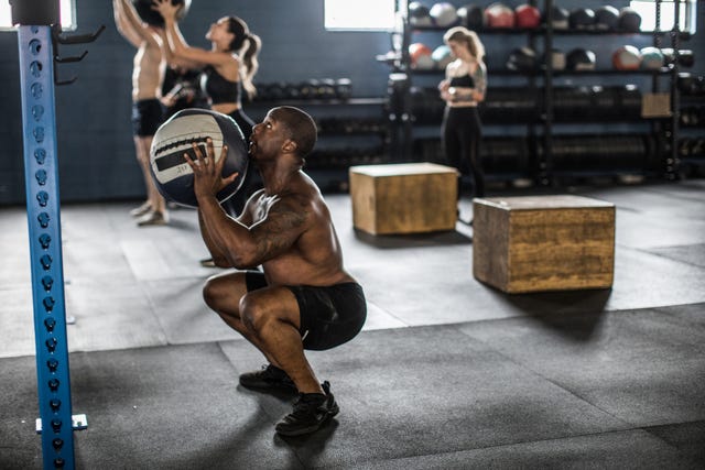 https://hips.hearstapps.com/hmg-prod/images/man-using-medicine-ball-at-cross-training-gym-royalty-free-image-1617118485.?crop=0.669xw:1.00xh;0.0505xw,0&resize=640:*