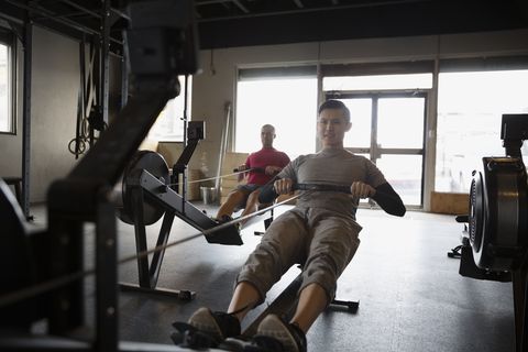 Man using rowing machine at gym
