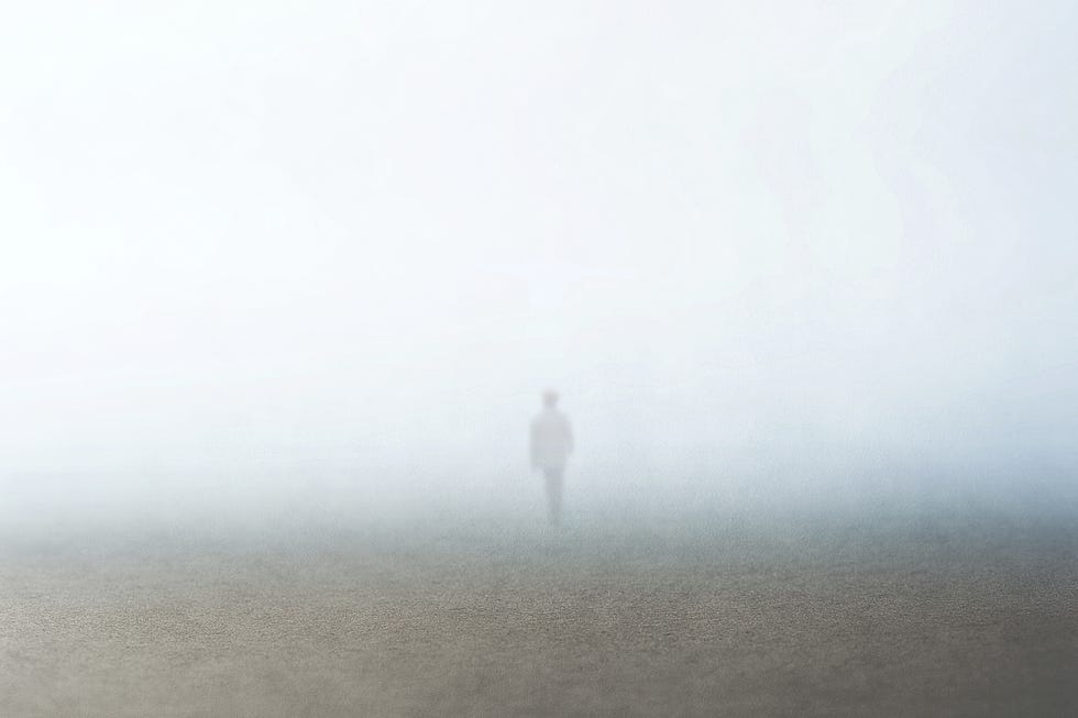 man walking in the fog