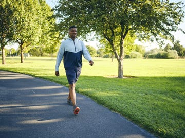 person walking on a path in a park