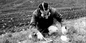 A man taking a sample from the ground