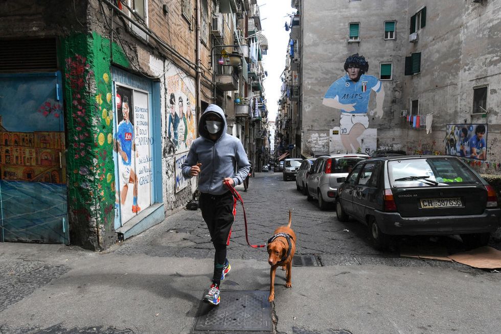Man walking dog in Naples