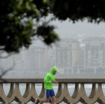 man running in wind and rain storm