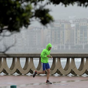man running in wind and rain storm