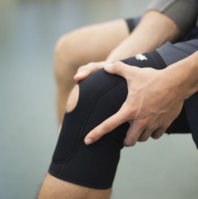 man wearing knee brace, cropped