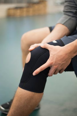 man wearing knee brace, cropped