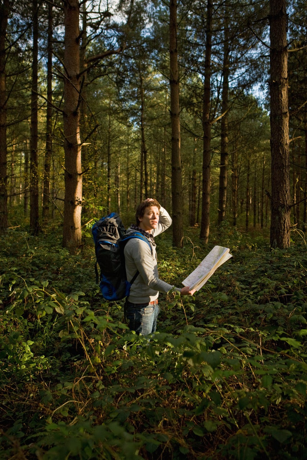 man with backpack lost in a forest