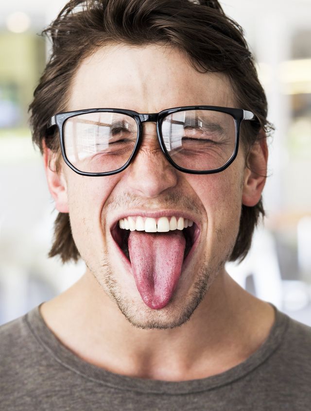 Man with glasses with his tongue out