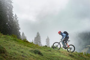 man with pedelec riding uphill in mountains, saalfelden, tyrol, austria