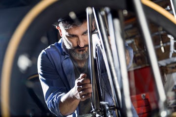 man working on bicycle in workshop