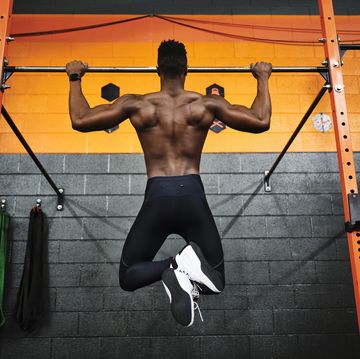 man working out in a gym doing pullups