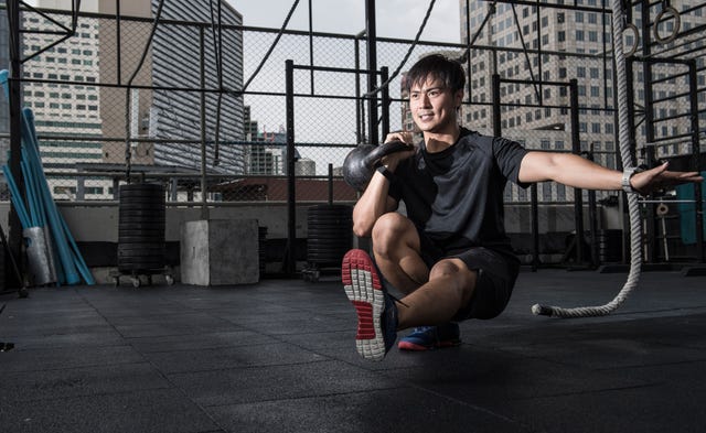 Man working out in rooftop gym, Asok, Bangkok, Thailand