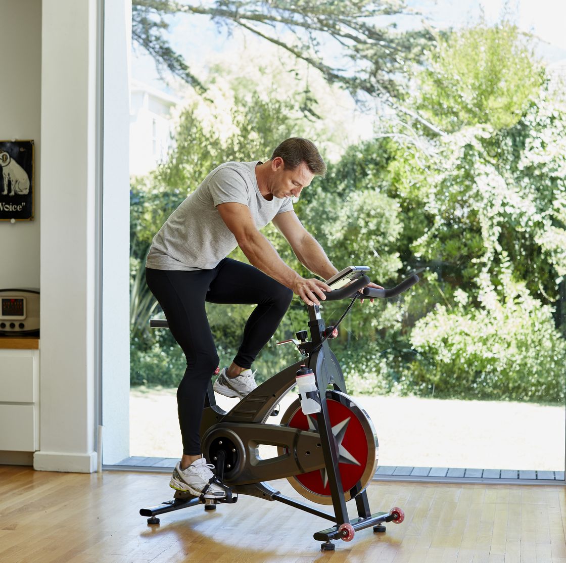 man working out on exercise bike at home