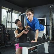 a man working out with a trainer